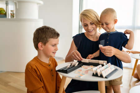 Happy children and women having fun time and playing together. Family, kindergarten, kids conceptの写真素材