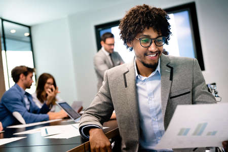 Group of business partners discussing documents and ideas at meetingの写真素材