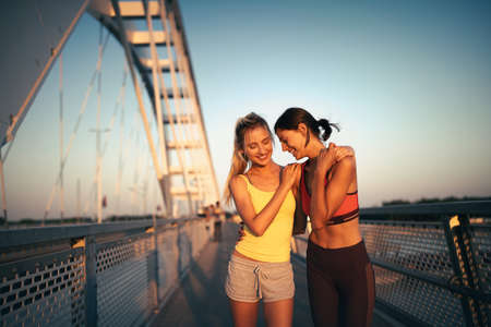 Outdoor portrait of group of friends running and exercising in cityの写真素材