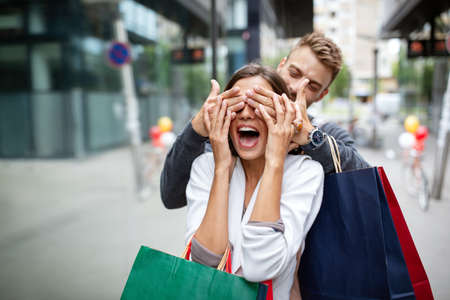 Beautiful young couple enjoying in shopping, having fun together.の写真素材
