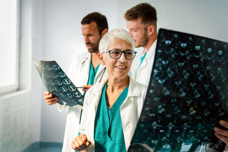 Group of radiology doctor looking at x-ray and discussing it.の写真素材