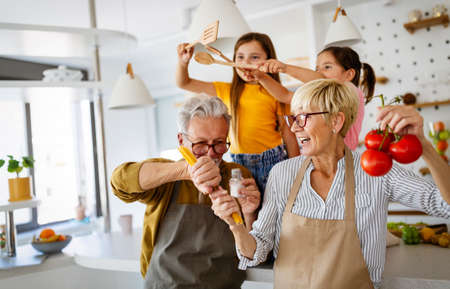 Happy grandparents having fun times with children at home