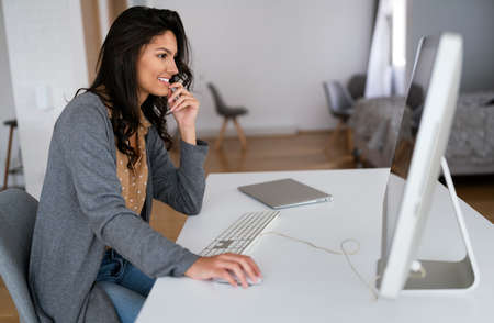 Attractive business woman working on computer. Business technology people concept.