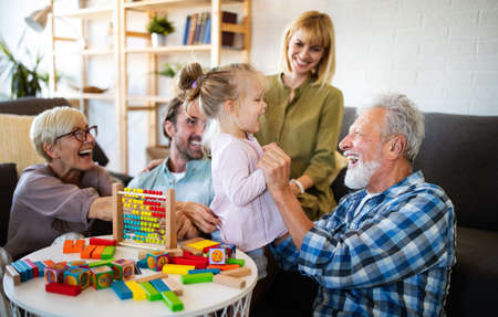 Senior grandparents playing with grandchildren and having fun with familyの写真素材
