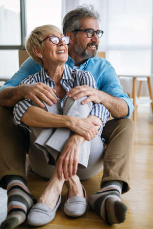 Portrait of happy senior couple in love moving in new homeの写真素材