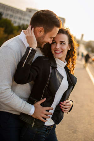 Happy couple having fun on a sunny day in the city.の写真素材