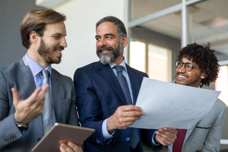 Group of coworkers working together on business project in modern officeの写真素材