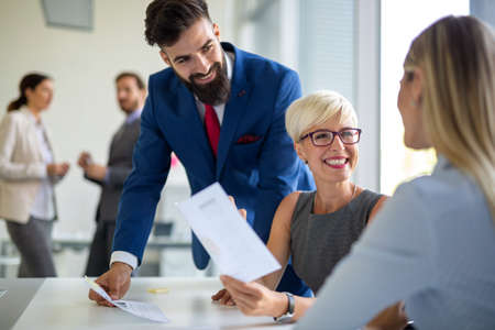 Group of coworkers working together on business project in modern office