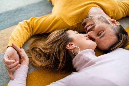 Happy couple in love hugging and enjoying time together at home