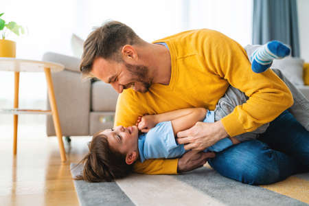 Family, childhood, single parent concept. Happy father and little son having fun together at home