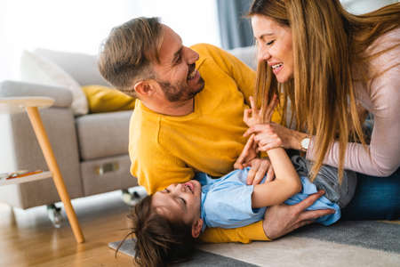 Young happy family being playful and having fun at home