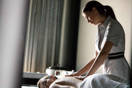 Attractive young healthy woman in spa salon having massageの写真素材