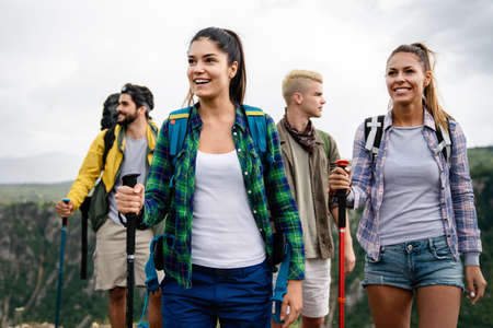Group of young friends hiking in countryside. Multiracial happy people travellingの写真素材