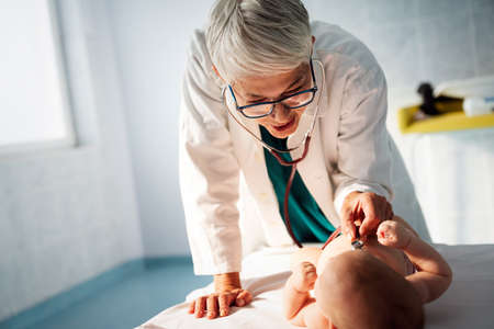 Pediatrician doctor examines baby. Healthcare, people, examination conceptの写真素材