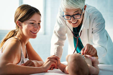 Portrait of happy mother with baby, medical pediatrician doctors, nurse