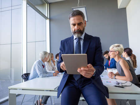 Handsome mature businessman, leader working in the office
