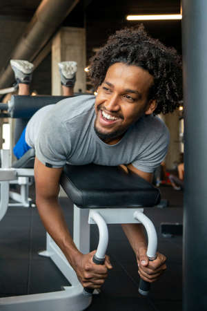 Confident fit young man exercising at fitness center.の写真素材