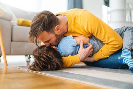 Family, childhood, single parent concept. Happy father and little son having fun together at homeの写真素材