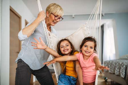 Happy grandparent playing, having fun with grandchildrenの写真素材