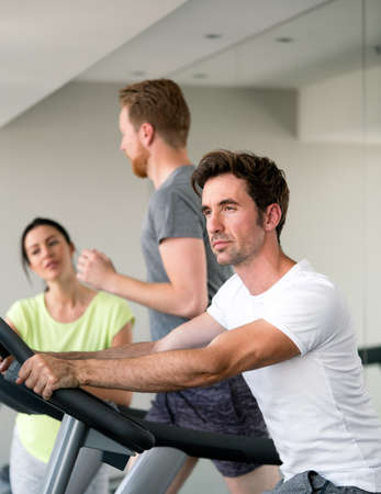 Young fit people cardio workout at gym