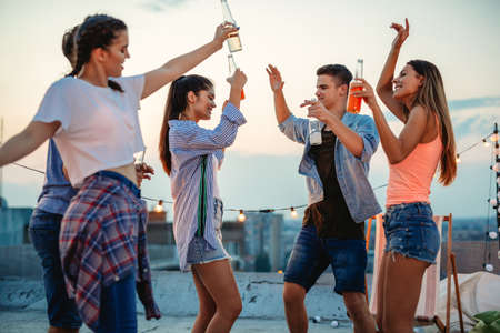 Group of happy friends having fun at rooftop party.の写真素材