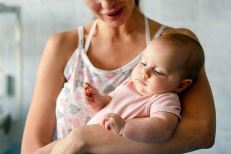 Happy cheerful family. Mother and baby kissing, laughing and huggingの写真素材