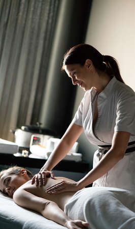 Healthy woman having massage therapy at spa salonの写真素材