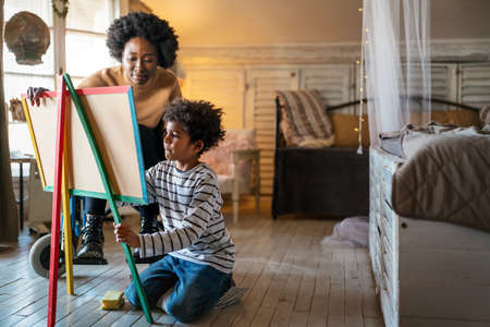 Happy child doing math exercises with her mother ot teacher together. Education people fun conceptの写真素材