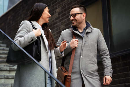Portraite of handsome man and beautiful woman as business partners working talking outdoorの写真素材