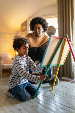 Happy child doing math exercises with her mother ot teacher together. Education people fun conceptの写真素材