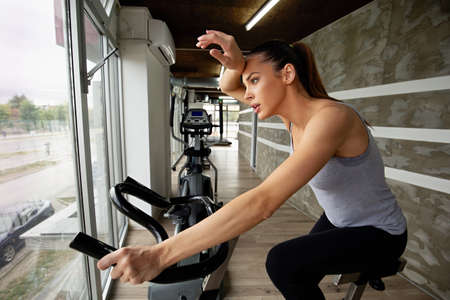 Attractive fit woman exercising in gym. Sport healthy lifestyle people concept