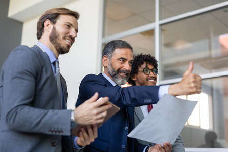 Business team working together on meeting, analyzing financial documents in office