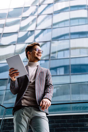 Portrait of successful business man, entrepreneur working in urban backgroundの写真素材