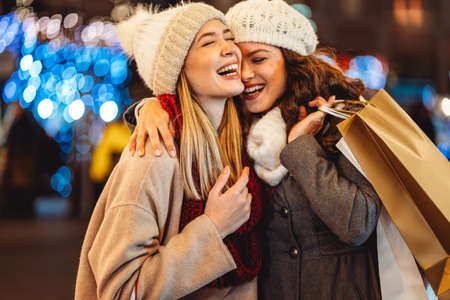 Happy women friends having fun and shopping at Christmas. Sale xmas people happiness conceptの写真素材