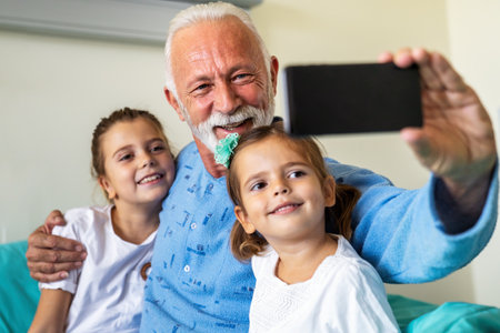 Happy grandfather is recovering from the coronavirus is visited by his grandchildren