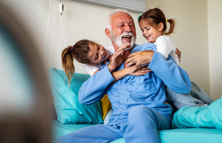 Little girls visiting grandfather in hospital, who is recovering from coronavirus.の写真素材