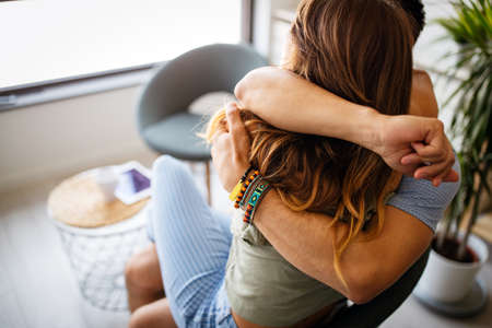 Romantic happy young couple relax at home, have fun and hugging