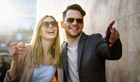 Happy smiling couple having fun together in city. People travel business happiness concept