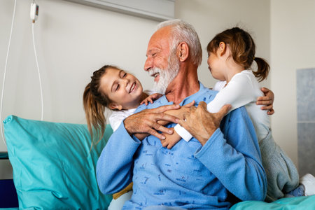 Happy recovering grandfather is visited by his grandchildren in the hospital.