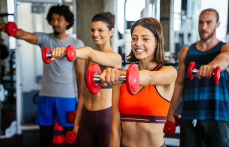 Group of happy people friends working out in gym togetherの写真素材