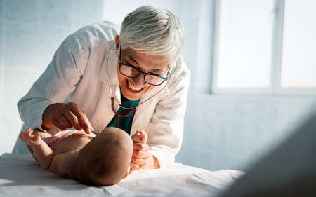 Pediatric doctor exams little baby. Health care, medical examination, people conceptの写真素材