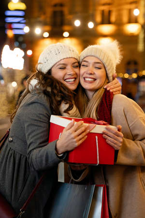 Portrait of happy women exchanging christmas presents. Holiday people christmas happiness concept