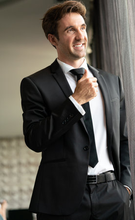 Portrait of a handsome young happy businessman in suitの写真素材