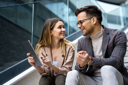 Business people having fun, working and chatting at workplace officeの写真素材