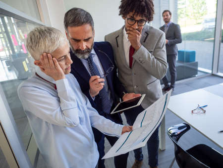 Business, teamwork, people and crisis concept. Business people solving problem in officeの写真素材