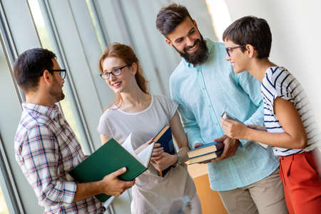 Education campus friendship people concept. Group of happy students studying together in library.の写真素材