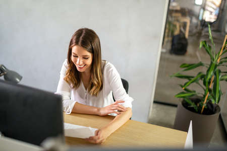 Portrait of happy smiling businesswoman working in office or from home