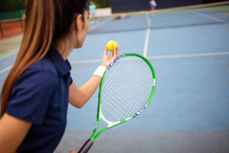 Portrait of happy fit young woman playing tennis. People sport healthy lifestyle conceptの写真素材