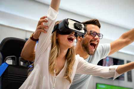 Portrait of happy people having fun with virtual reality glasses. Couple using new vr headset