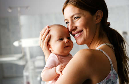 Beautiful mother and her newborn baby together. Love, happiness, family concept.の写真素材